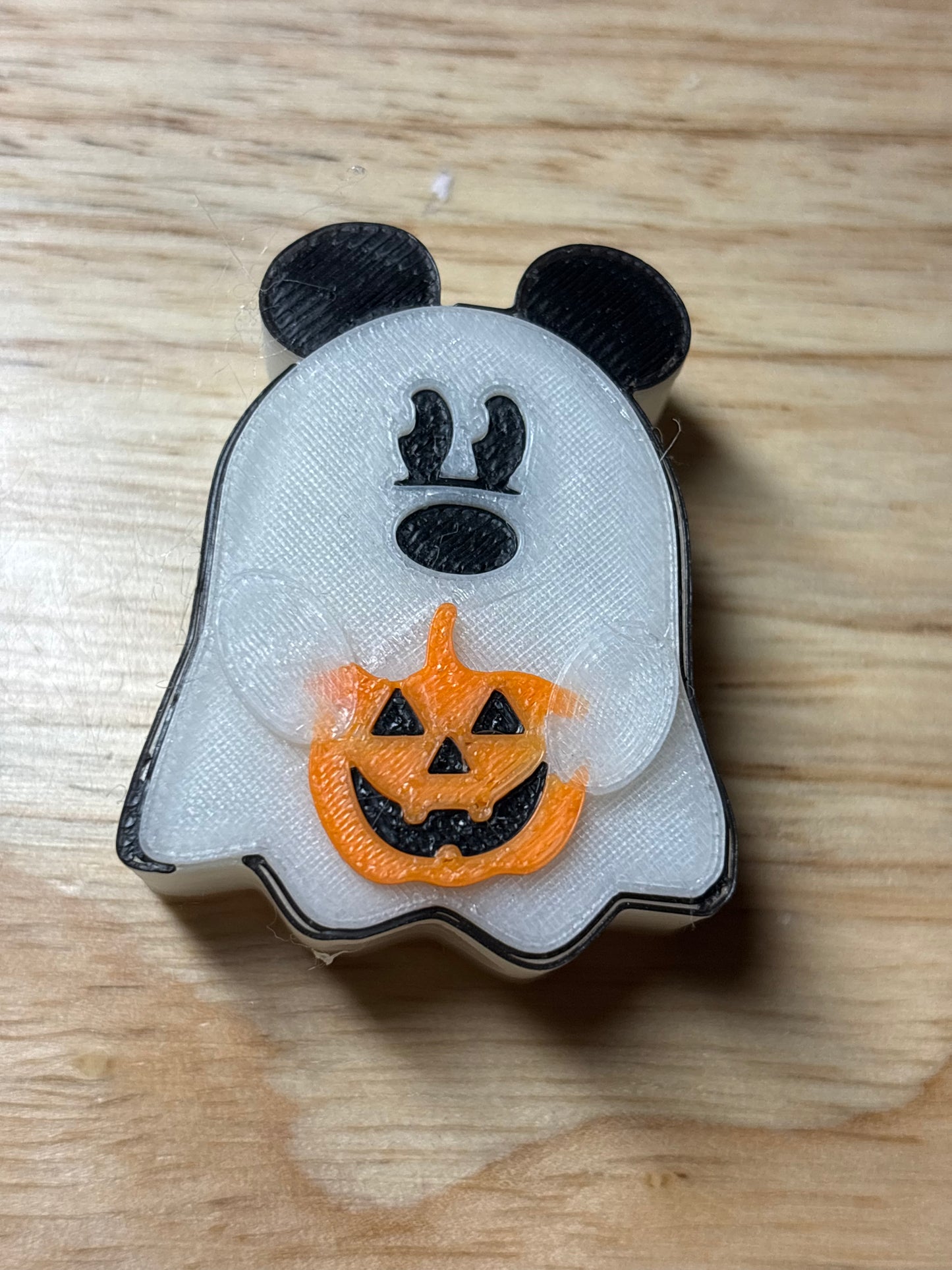 Mouse ghost holding pumpkin